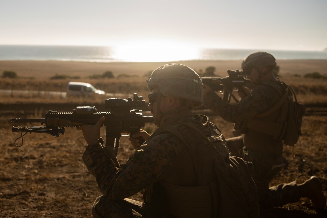 U.S. Marine Corps Cpl. Nicholas McCready, a fire team leader, and Lance Cpl. Dalton Noyes, both assigned to Fleet Anti-terrorism Security Team Company, Europe post security during a hike as part of exercise Lisa Azul in Sierra del Retin, Spain, Sept. 15, 2022. Lisa Azul is an annual bilateral training exercise that takes place aboard Naval Station Rota and Sierra del Retin and focuses on critical skills such as live-fire, helicopter rope suspension techniques, non-lethal combatives, and physical fitness to foster camaraderie and sustain interoperability amongst U.S. and partner forces and improve lethality in security and infantry operations. (U.S. Marine Corps Photo by Lance Cpl. Tyler M. Raab)