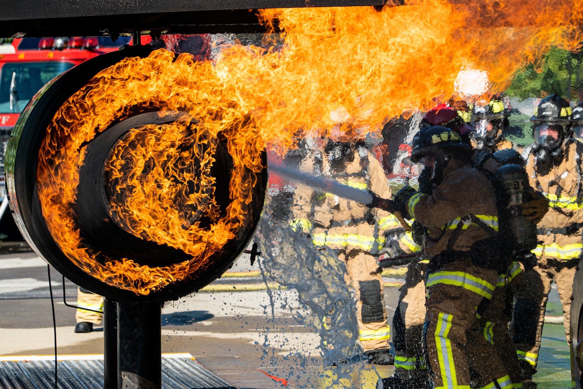 914th Fire Emergency Services members work together to extinguish an aircraft fire during a training scenario
