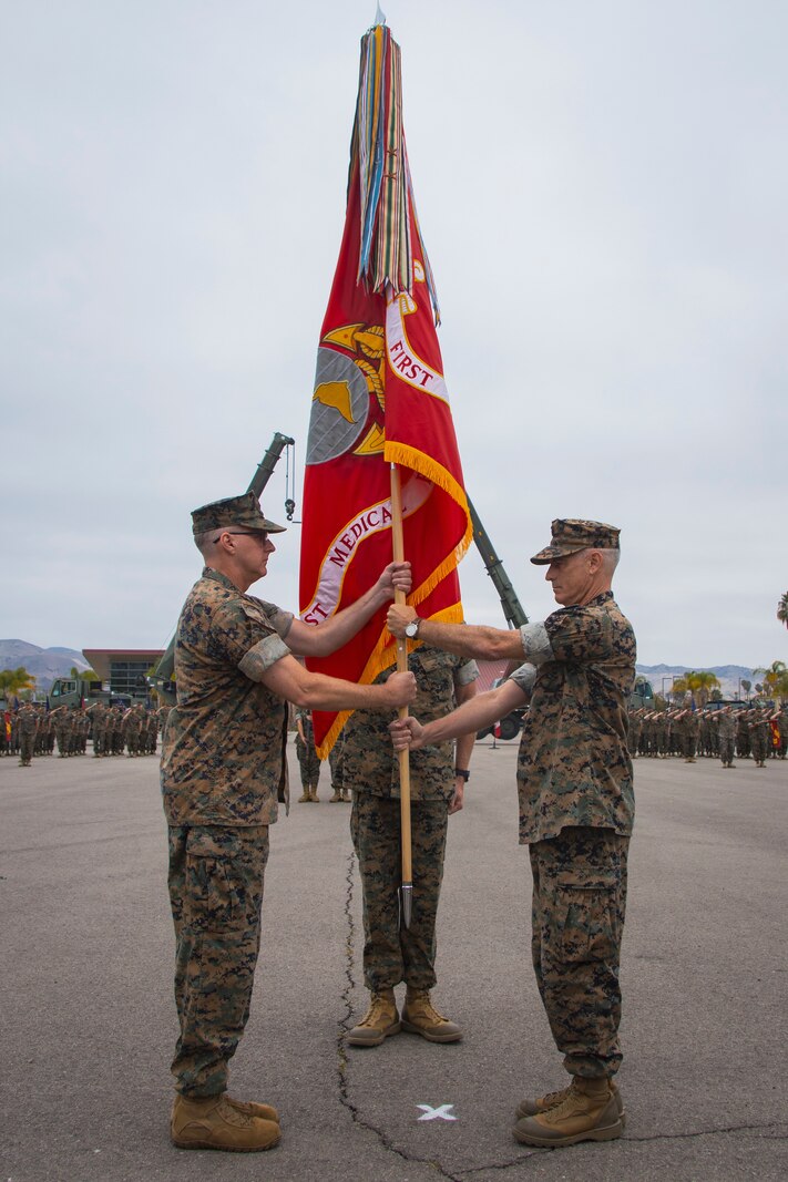 U.S. Navy Capt. Jeffery J. Repass, outgoing commanding officer of 1st Medical Battalion, 1st Marine Logistics Group, I Marine Expeditionary Force, relinquishes command to oncoming commanding officer U.S. Navy Capt. Sean M. Hussey during a change of command ceremony on Camp Pendleton, California, July 8, 2022
