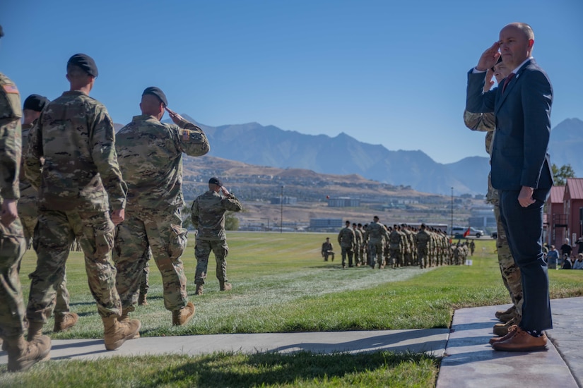 Gov. Spencer J. Cox salutes Utah Army National Guard Soldiers as they march during the 67th Annual Governor’s Day at Camp Williams, Utah, Sept. 24, 2022.