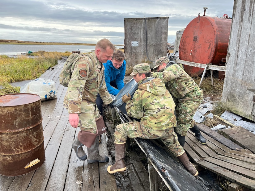 Alaska National Guardsmen of Joint Task Force-Bethel clear storm debris from a boardwalk in Newtok, Alaska as part of Operation Merbok Response, Sept. 22, 2022. Approximately 100 members of the Alaska Organized Militia, which includes members of the Alaska National Guard, Alaska State Defense Force and Alaska Naval Militia, were activated following a disaster declaration issued Sept. 17 after the remnants of Typhoon Merbok caused dramatic flooding across more than 1,000 miles of Alaskan coastline. (Alaska National Guard photo by 1st Lt. Balinda O'Neal)