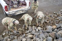 Service members assigned to Joint Task Force – Bethel repair a road in Tununak, Alaska, as part of Operation Merbok Response, Sept. 22, 2022. More than 130 members of the Alaska Organized Militia, which includes members of the Alaska National Guard, Alaska State Defense Force and Alaska Naval Militia, were activated following a disaster declaration issued Sept. 17 after the remnants of Typhoon Merbok caused dramatic flooding across more than 1,000 miles of Alaskan coastline. (Alaska National Guard photo by Staff Sgt. Kelly Willett)