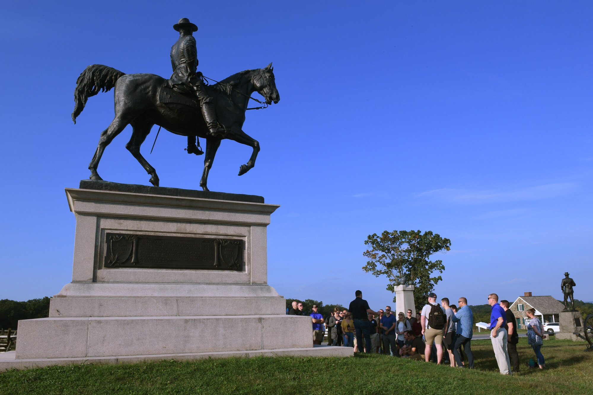 193rd Special Operations Wing Airmen huddle under the statue of Union General John Reynolds, the first general killed in action at the Battle of Gettysburg, during a tour given by the Army War College in Gettysburg, Pennsylvania September 19, 2022.