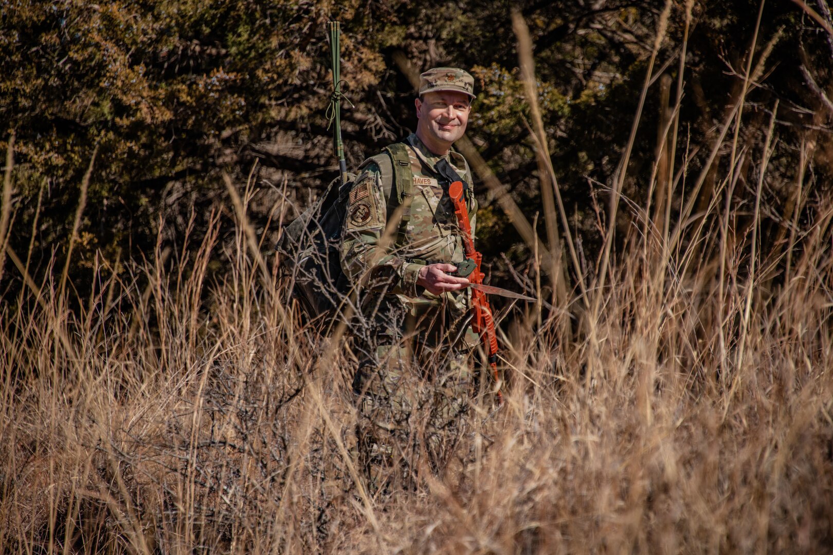 man hikes through field