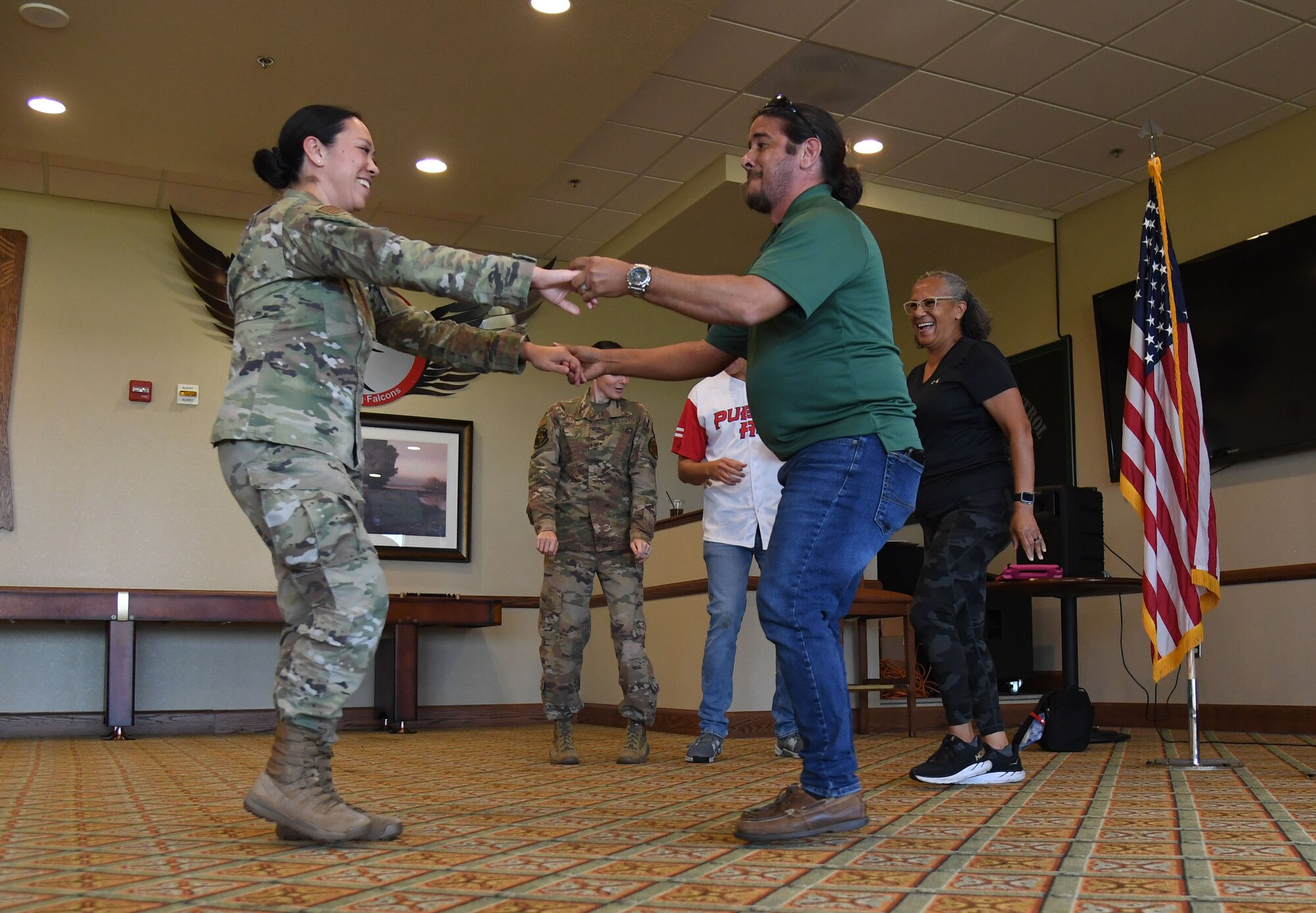 Keesler personnel participate in dance lessons during the Hispanic Heritage Month event inside the Bay Breeze Event Center at Keesler Air Force Base, Mississippi, Sept. 23, 2022. Dominos were also played during the event. Hispanic Heritage Month is celebrated September 15 through October 15. (U.S. Air Force photo by Kemberly Groue)