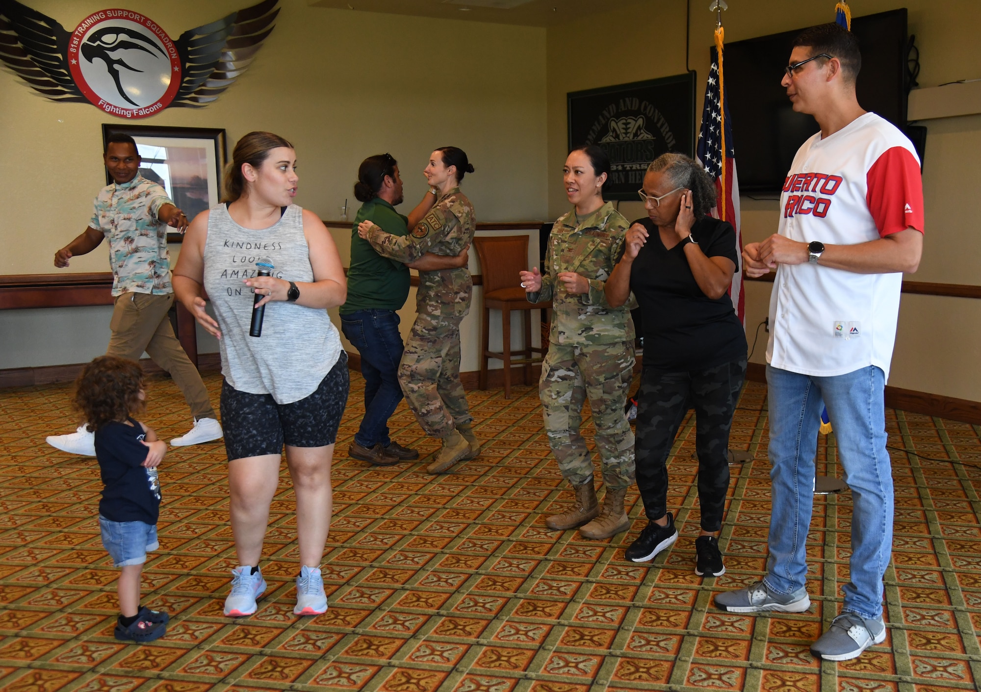 Keesler personnel participate in dance lessons during the Hispanic Heritage Month event inside the Bay Breeze Event Center at Keesler Air Force Base, Mississippi, Sept. 23, 2022. Dominos were also played during the event. Hispanic Heritage Month is celebrated September 15 through October 15. (U.S. Air Force photo by Kemberly Groue)