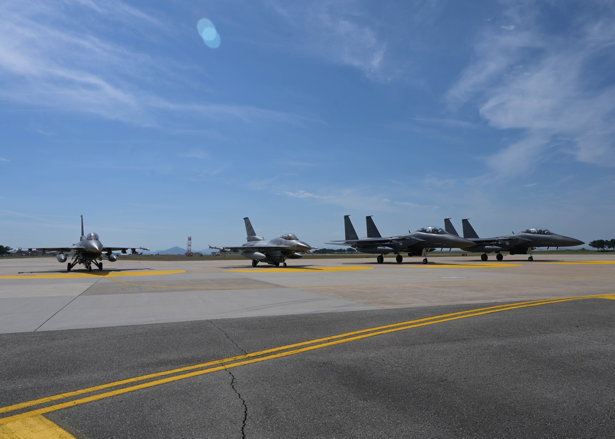 U.S. Air Force F-16 Fighting Falcons assigned to the 8th Operations Group and Republic of Korea Air Force F-15K Slam Eagles assigned to the 110th Fighter Squadron sit on the flightline at Kunsan Air Base, Republic of Korea, Sept. 22, 2022. “Buddy Squadron”, a bilateral training event, is designed to increase mission focus of partnered nations. (U.S. Air Force photo by Staff Sgt. Isaiah J. Soliz)