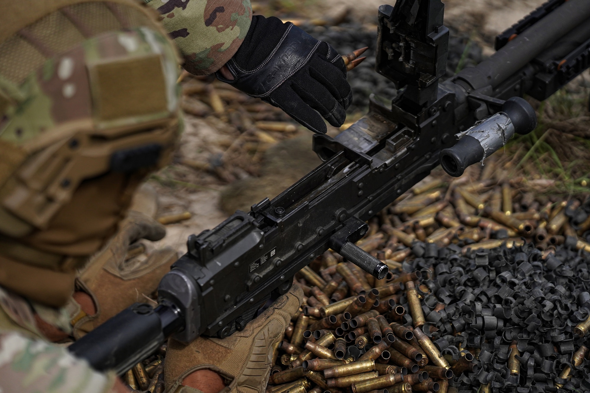 U.S. Air Force Airman Tyron Bennett, 81st Security Forces Squadron entry controller, fires M240B on range 14 B at Camp Shelby, Mississippi, Sept. 23, 2022. Defenders rotate through firing different heavy weapon systems to hone their defense capabilities. (U.S. Air Force photo by Airman 1st Class Trenten Walters)
