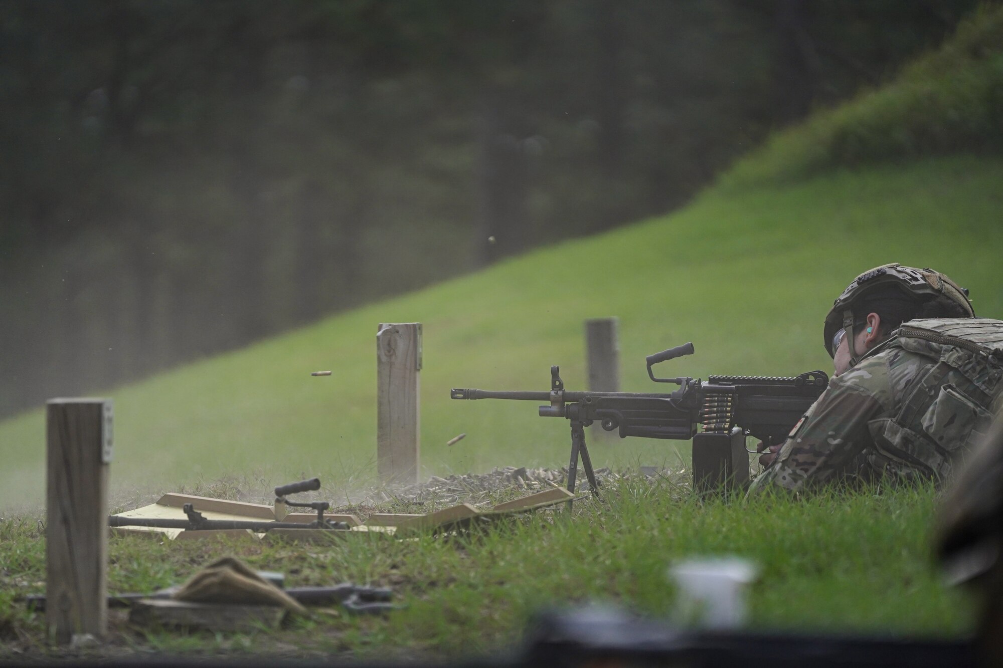 U.S. Air Force Airman Brianna Ramos, 81st Security Forces Squadron entry controller, fires M249 on range 14 B at Camp Shelby, Mississippi, Sept. 23, 2022. Defenders rotate through firing different heavy weapon systems to hone their defense capabilities.
