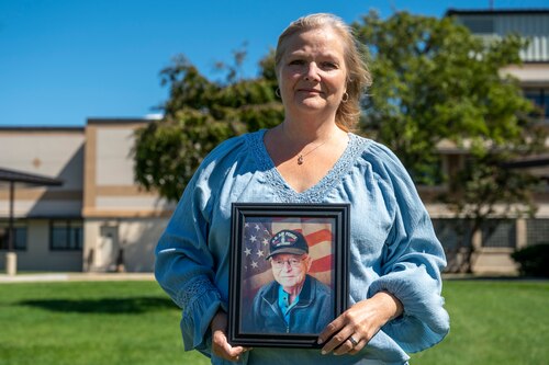 RaeAnn Rivera holds a photo of her father, Master Sgt. (Ret.) Eugene LaJudice, in front of the 436th Medical Group at Dover Air Force Base, Delaware, Sept. 23, 2022. Rivera was born at the hospital on Dover AFB during her father’s assignment and recently retired after 35 years of service as the technical and laboratory supervisor at the 436th MDG. (U.S. Air Force photo by Senior Airman Cydney Lee)