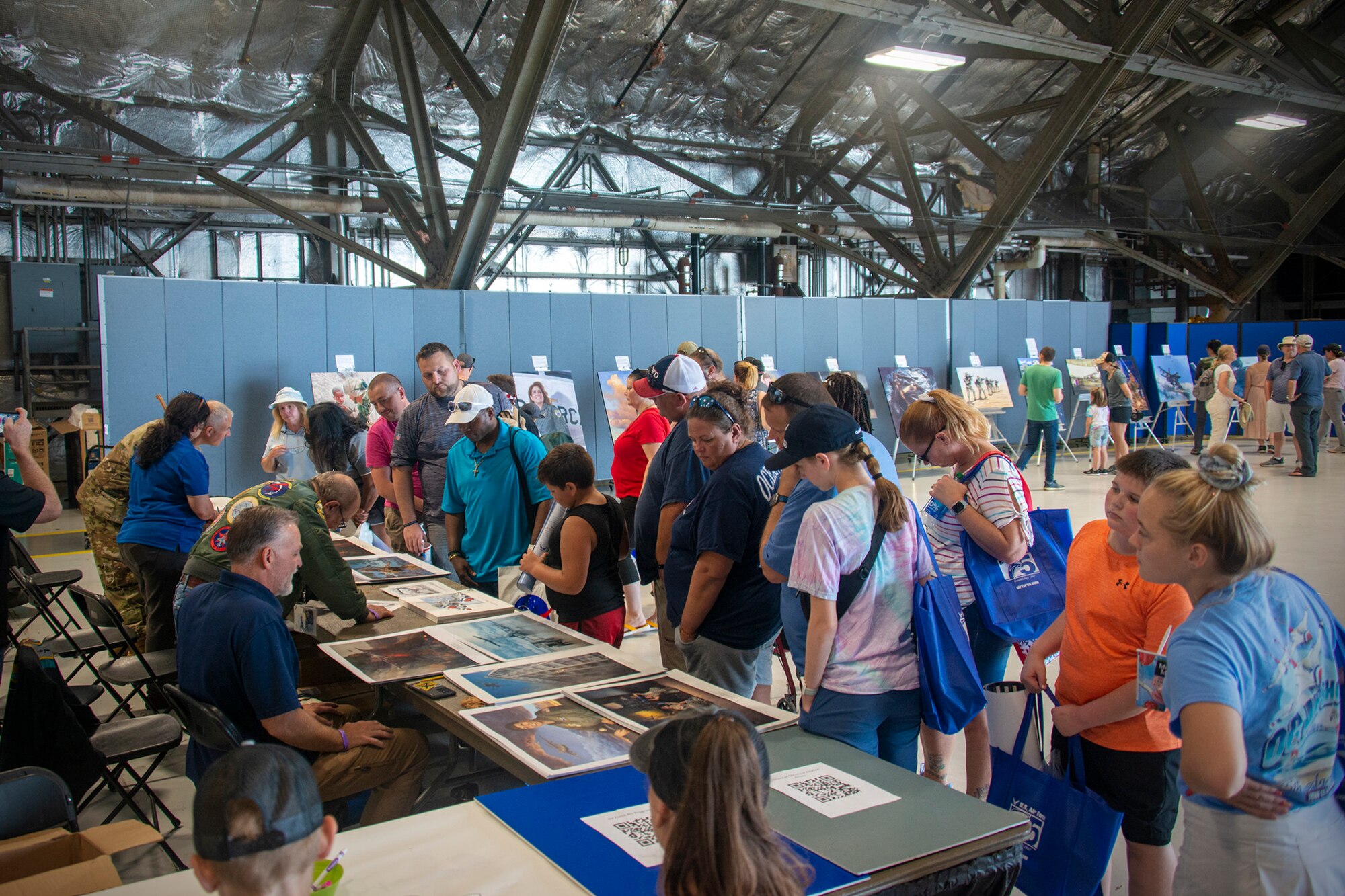 Crowd of people looking at Air Force Reserve Combat History 
art prints.
