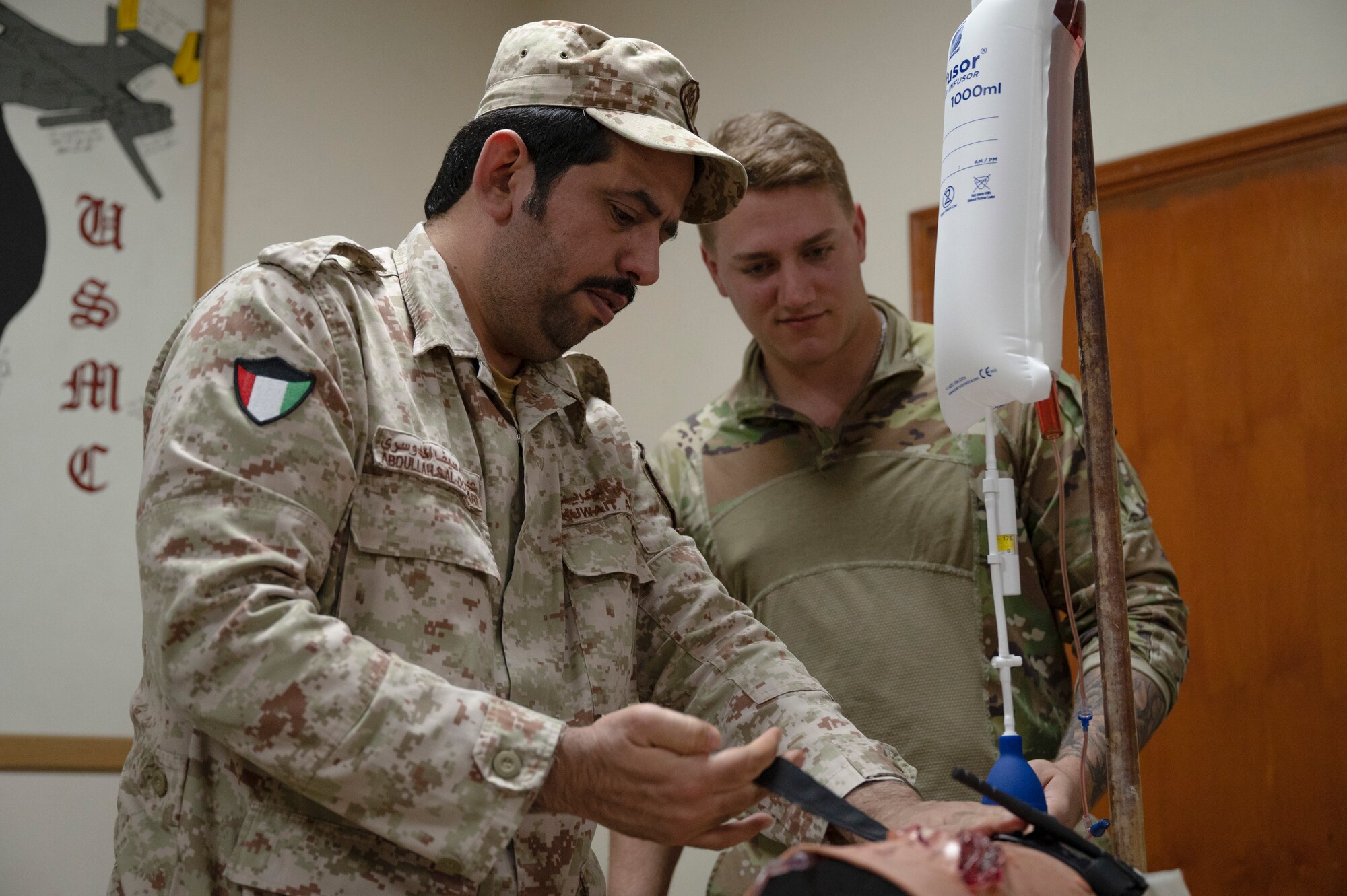 A Kuwait Army firefighter demonstrates how to properly apply a tourniquet to stop bleeding during a Tactical Combat Casualty Care class taught by Airman 1st Class Alex Moore, 386th Expeditionary Medical Squadron aerospace medical technician, September 14, 2022. During the training the firefighters volunteered for hands-on training to apply tourniquets, learning invaluable tools to save someone’s life in a crisis situation. (U.S. Air Force photo by Staff Sgt. Dalton Williams)
