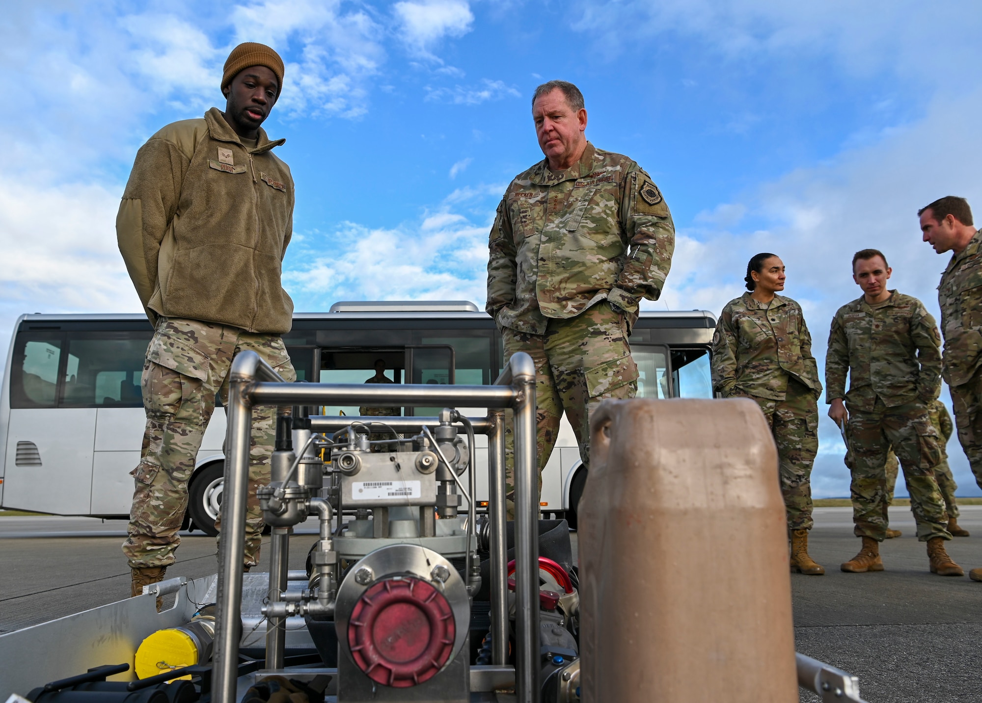 General James Hecker, U.S. Air Forces in Europe – Air Forces Africa commander (right), receives a brief from Senior Airman Maurice Pugh, 52nd Logistic Readiness Squadron fuel distribution operator, on the viper kit.