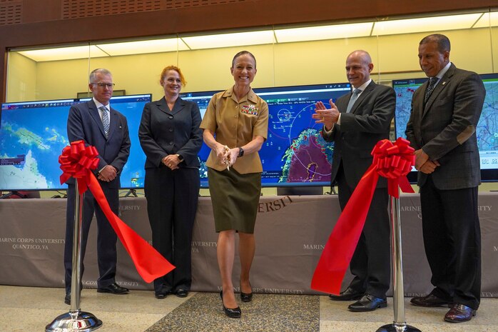 Keil Gentry, Vice President for Business Affairs, left, Rebecca Johnson, provost, Marine Corps University, middle left, U.S. Marine Corps Brig. Gen. Maura Hennigan, MCU President, middle, Tim Barrick, Director, Wargaming, Krulak Center for Innovation and Future Warfare, middle right, and Luis Velazquez, Chief Technology Officer, Marine Corps Systems Command, participate in the MCU Wargaming Cloud ribbon cutting ceremony at Warner Hall on Marine Corps Base Quantico, Virginia, Sept. 23, 2022. The Wargaming Cloud enables faculty and students of MCU to access a wide range of commercial and government wargaming tools using their personal devices from anywhere. (U.S. Marine Corps photo by Cpl. Eric Huynh)