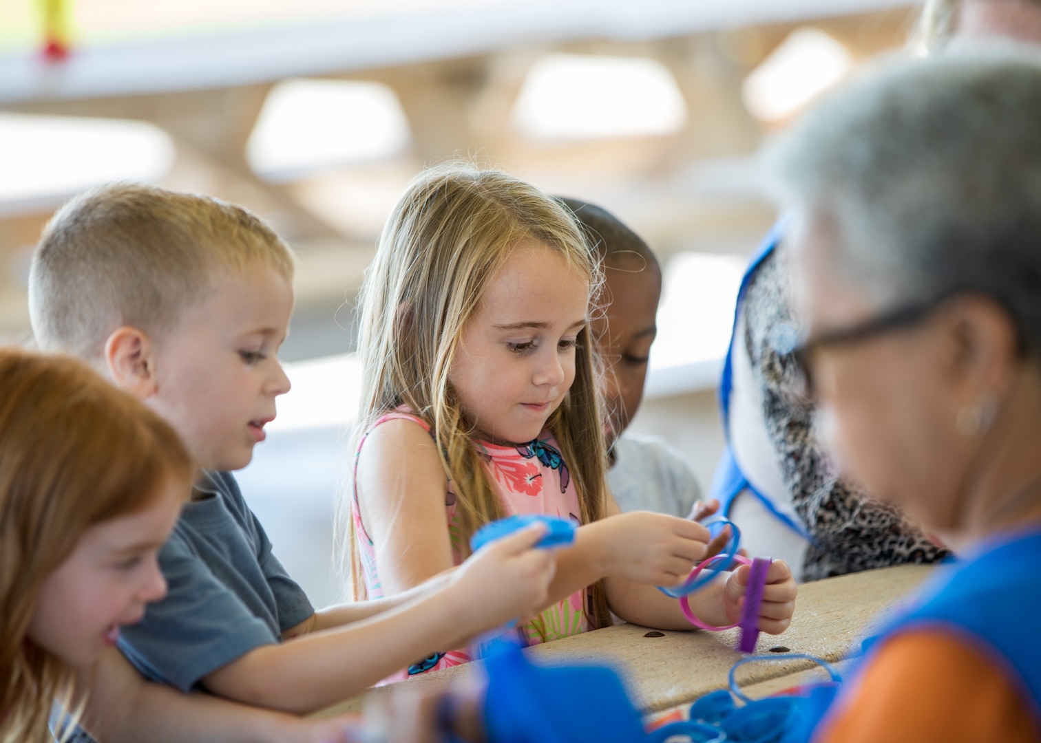 A group of children doing crafts at a table.