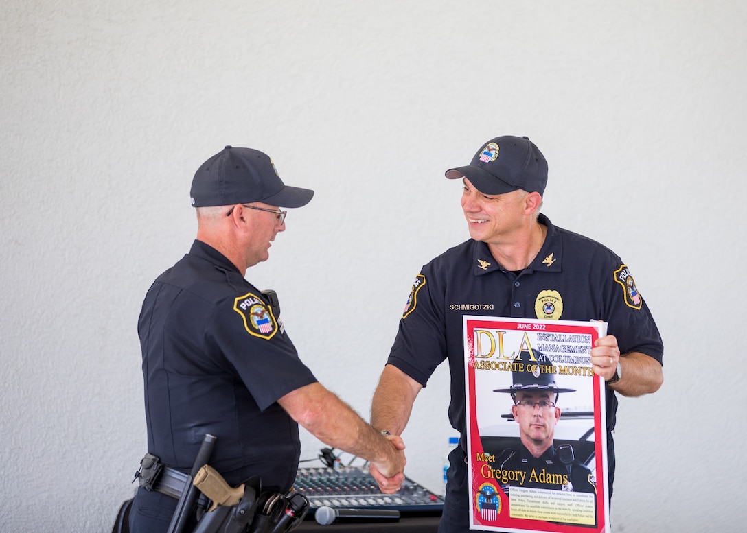 Two police officers shake hands.