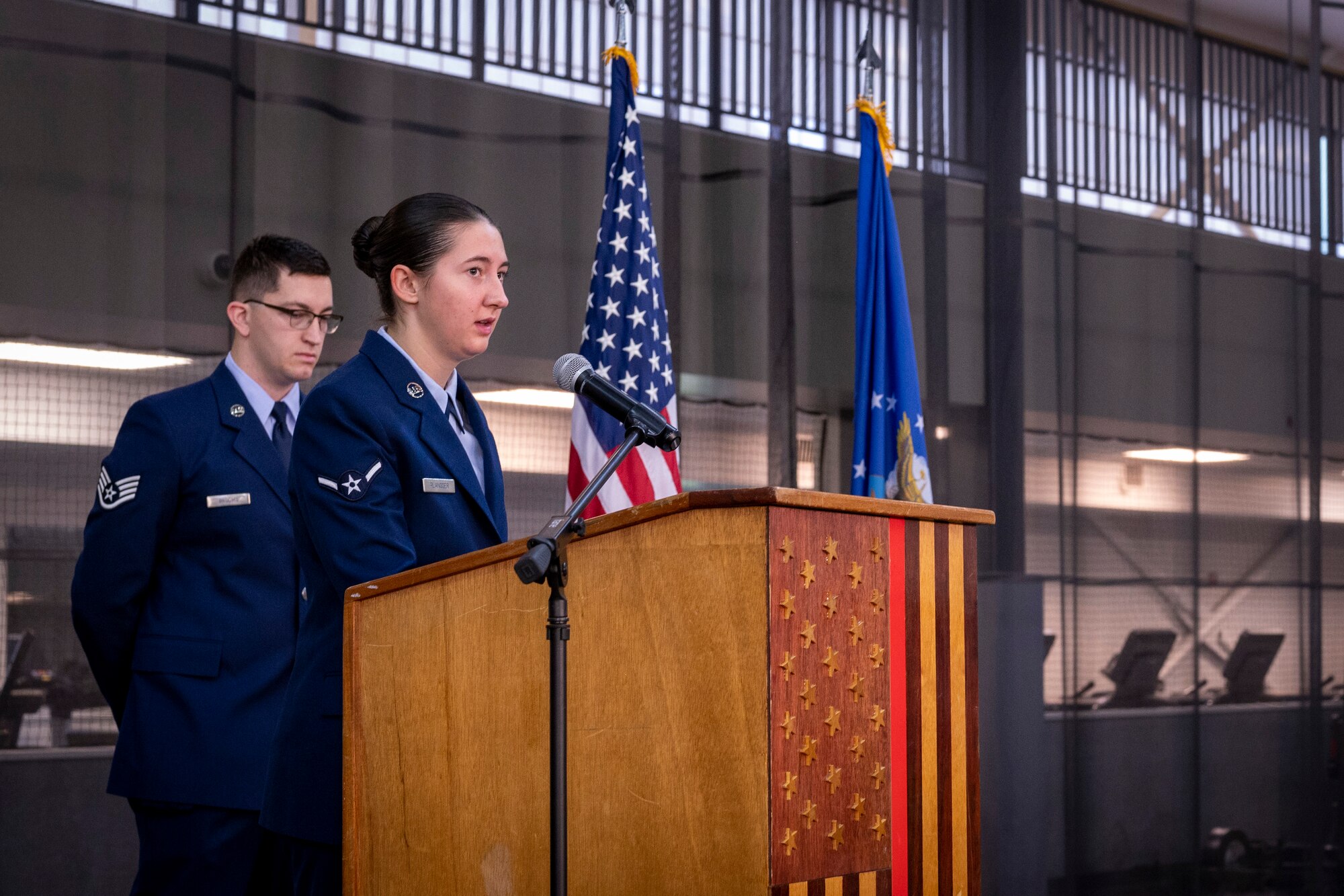 An airman reads a prayer during a ceremony