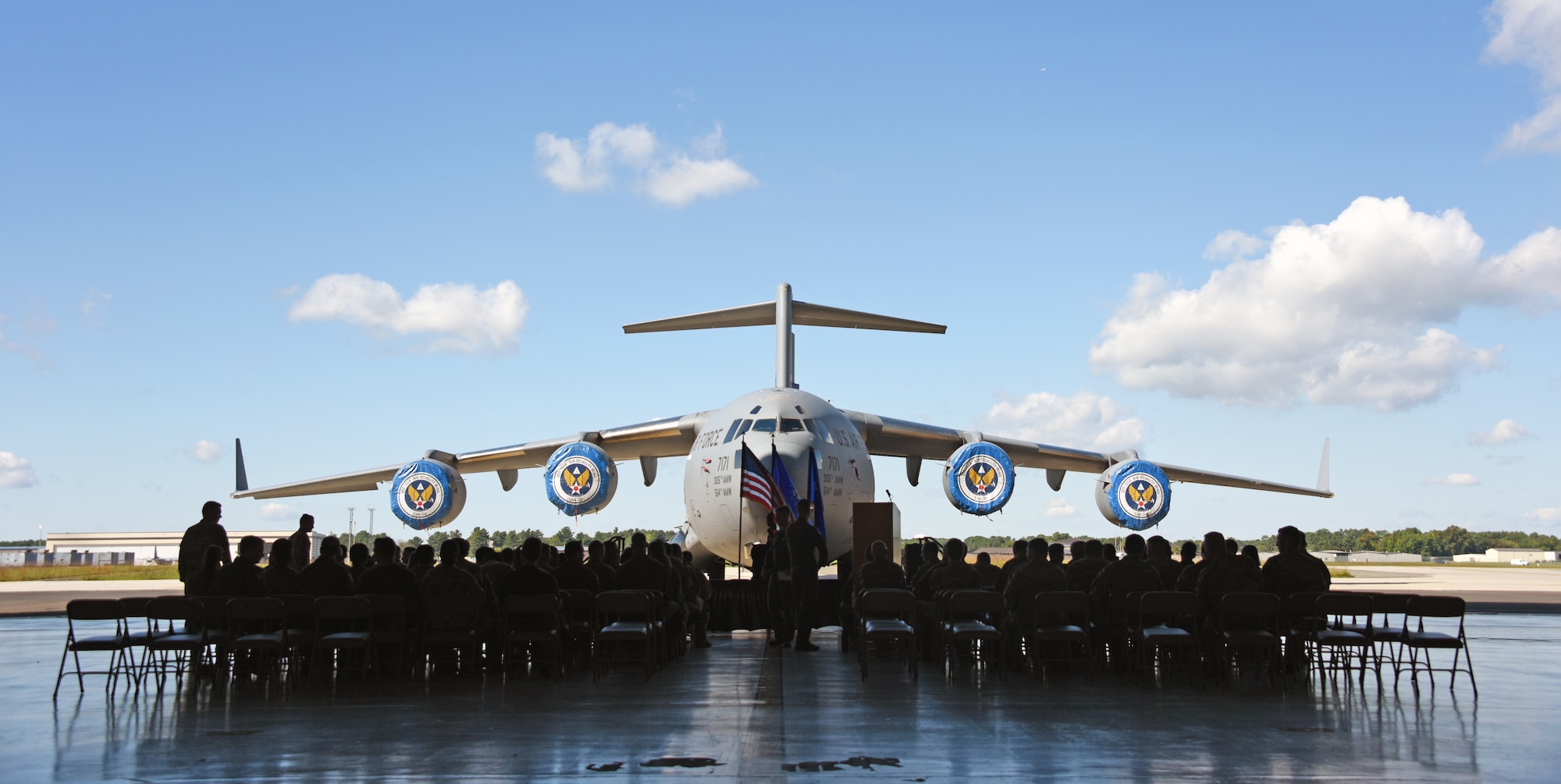 A C-17A Globemaster III is set as the backdrop for the 305th Air Mobility Wing’s ceremony for the presentation of the Chief of Staff of the Air Force 2021 Exceptional Aviator Award on Joint Base McGuire-Dix-Lakehurst, N.J., Sept. 26, 2022. The CSAF 2021 Exceptional Aviator Award was presented to U.S. Air Force Lt. Col. Eric Kut, 6th Airlift Squadron Chief of Group Standards and Evaluations, by the Order of the Daedalians for his actions as the aircraft commander of the REACH871 mission. This mission resulted in the ground evacuation of 823 Afghan civilians from Kabul while under enemy fire and allowed the Air Mobility Command commander to waive C-17 floor-load restrictions from 300 to 450 passengers, facilitating the evacuation of 124,000 personnel during the Air Force’s largest non-combatant evacuation operation in history. (U.S. Air Force photo by Daniel Barney)