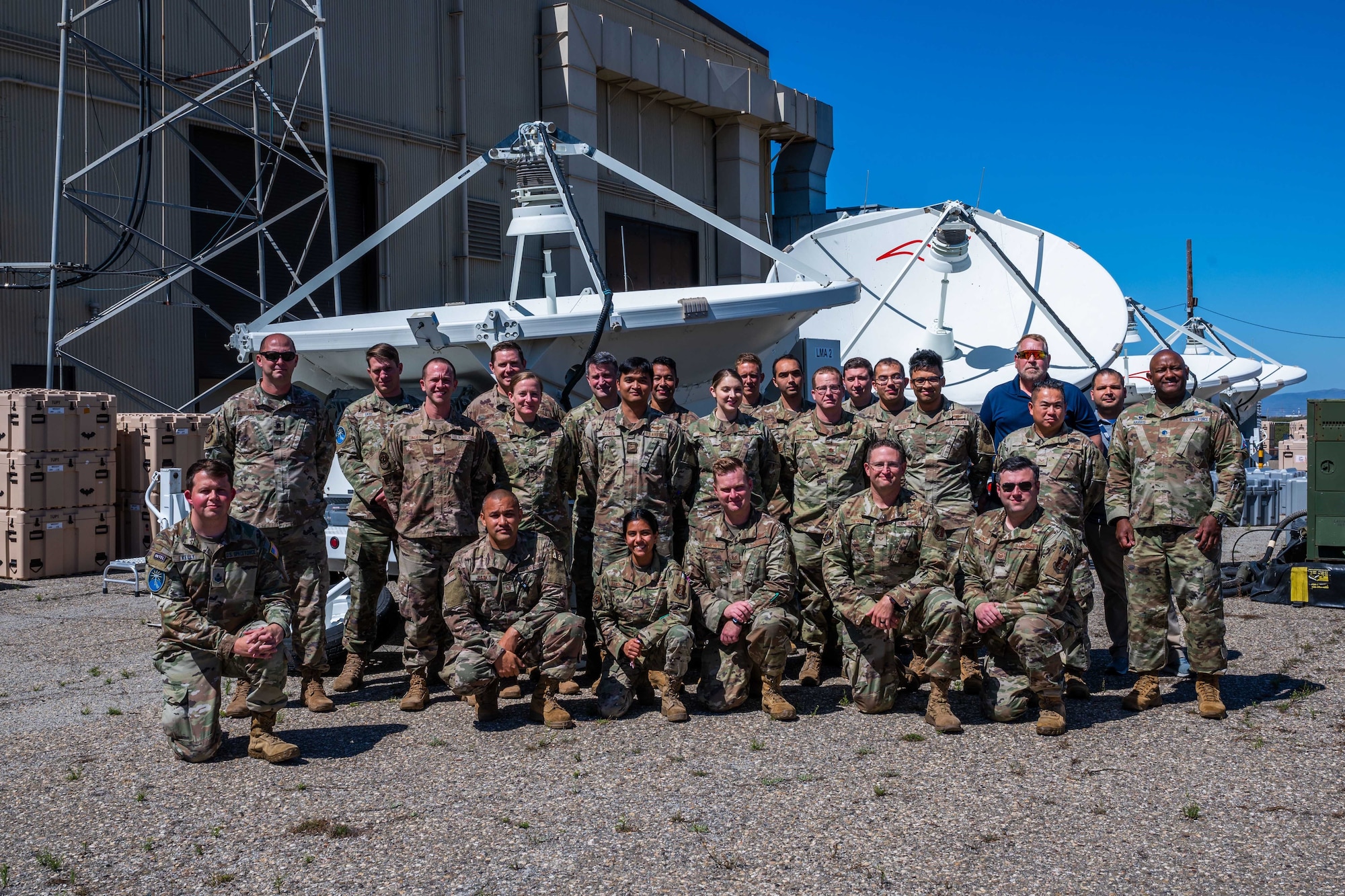 Members from the 392nd Combat Training Squadron (CTS) and the 216th Space Control Squadron (SPCS) take a group photo in front Electronic Warfare equipment during BLACK SKIES 22 at Vandenberg Space Force Base