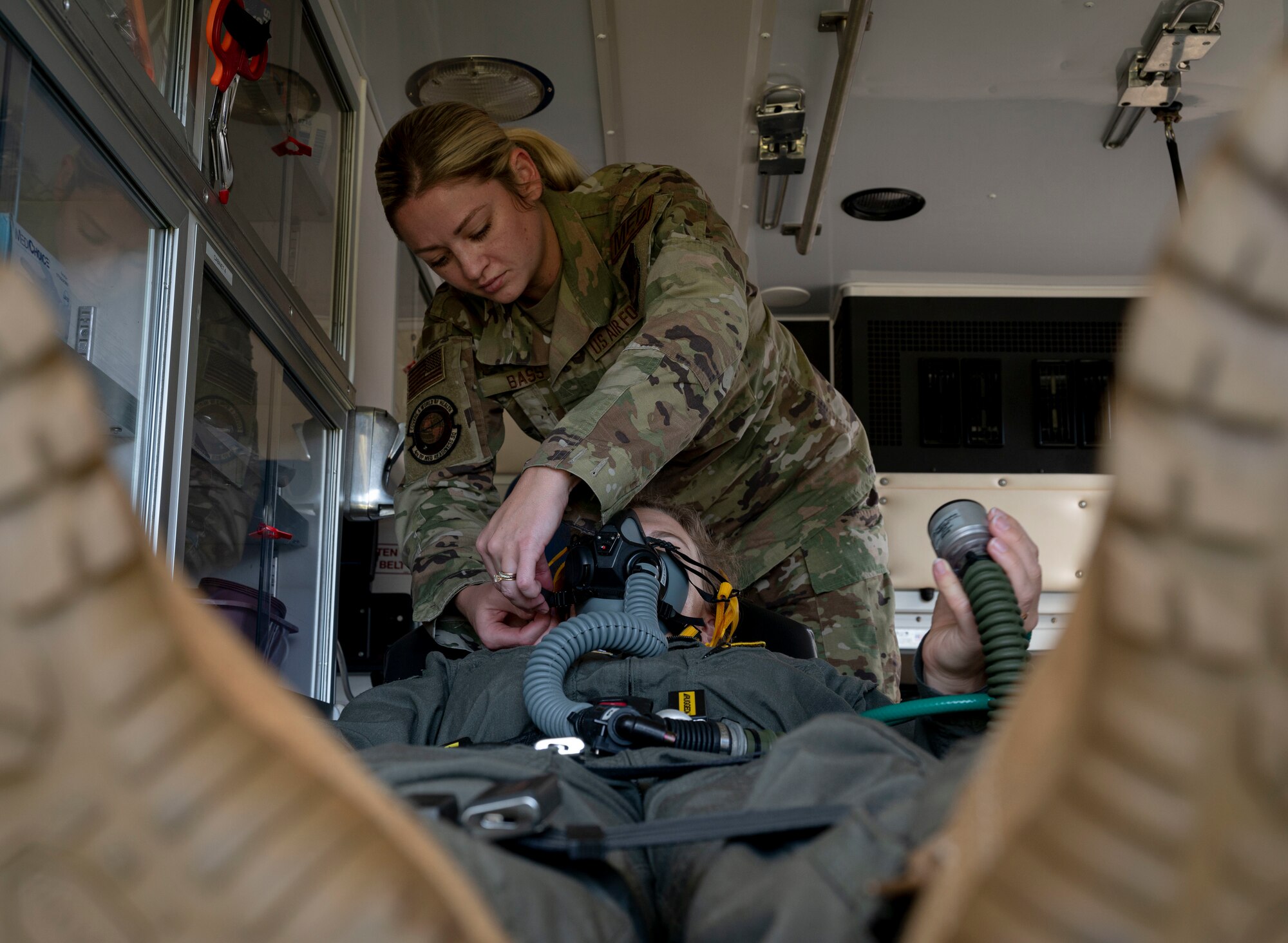 Tech. Sgt. Haley Bass, 4th Medical Group flight medicine NCO in charge, secures an aviator mask onto Capt. Karen Rodriguez, 4th MDG flight surgeon, at Seymour Johnson Air Force Base, North Carolina, Sept. 23, 2022. Some of flight medicine’s responsibilities include checking patients' vitals, oxygen consumption and providing transportation to a hospital. (U.S. Air Force photo by Airman 1st Class Sabrina Fuller)