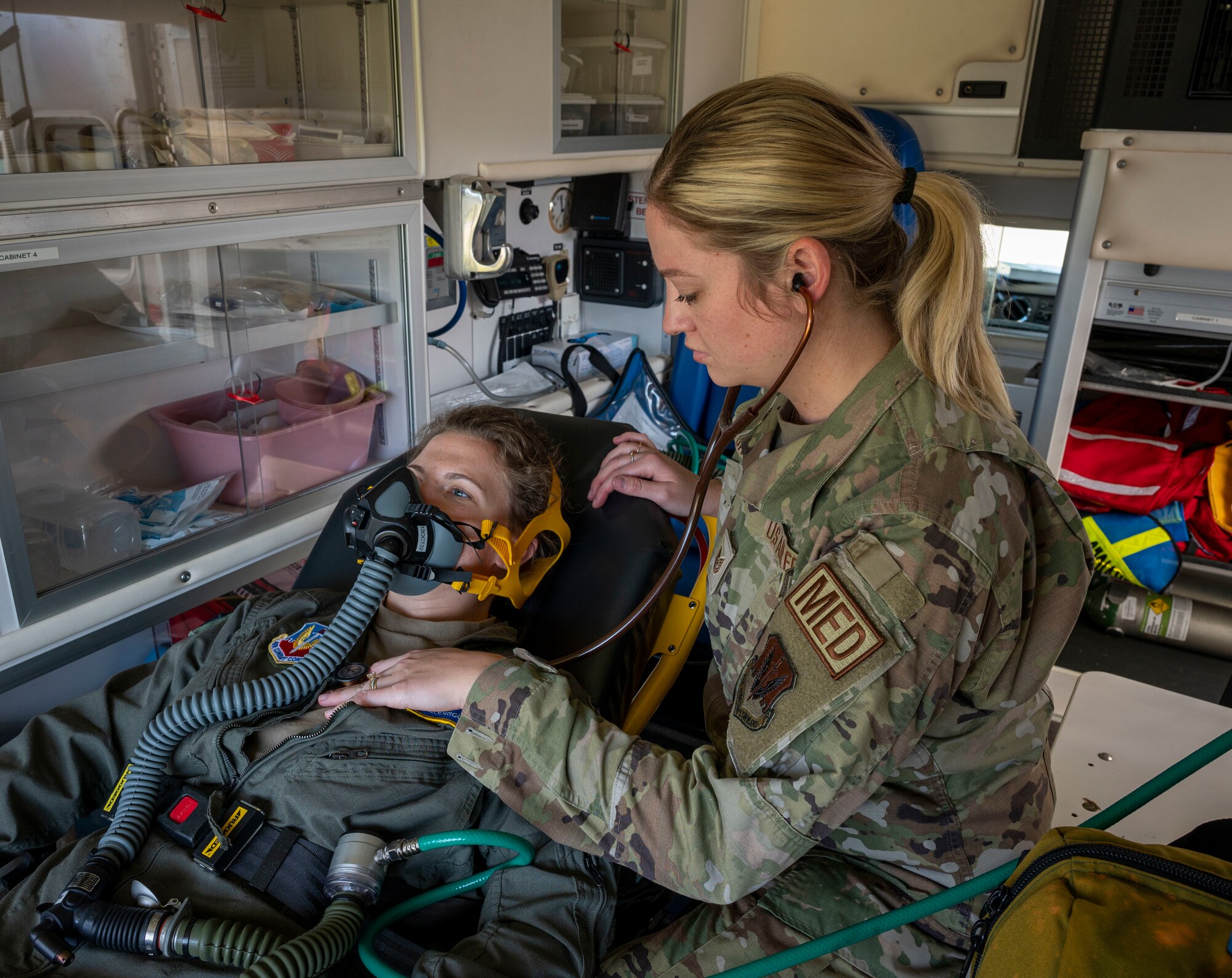 Tech. Sgt. Haley Bass, 4th Medical Group flight medicine NCO in charge, checks the vitals of Capt. Karen Rodriguez, 4th MDG flight surgeon at Seymour Johnson Air Force Base, North Carolina, Sept. 23, 2022. Some of flight medicine’s responsibilities include checking patients' vitals, oxygen consumption and providing transportation to a hospital. (U.S. Air Force photo by Airman 1st Class Sabrina Fuller)