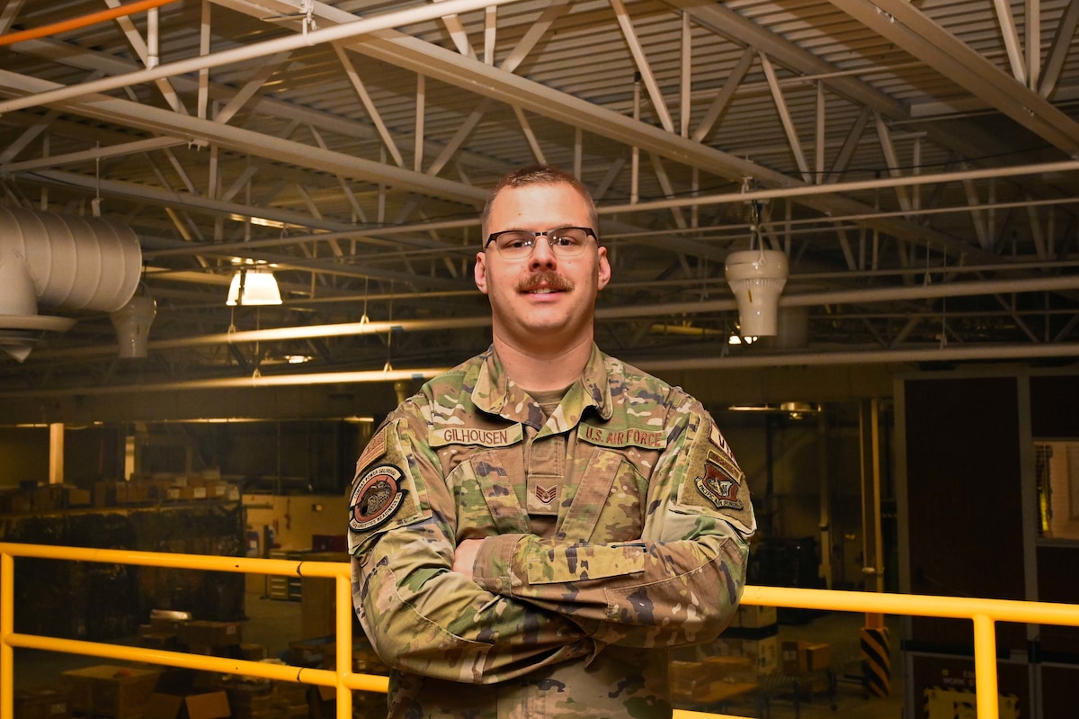 An airman poses for a photo