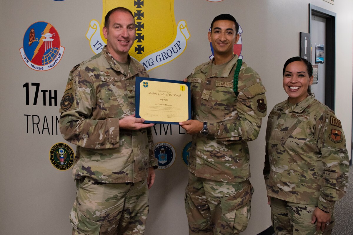U.S. Air Force Col. Jason Kulchar, 17th Training Group commander, and Chief Master Sgt. Valerie Nededog, 17th TRG senior enlisted leader, present the 315th Training Squadron Student Leader of the Month award to Airman 1st Class Sonny Haqauni, 316th Training Squadron student, at Goodfellow Air Force Base, Texas, September 26, 2022. Haqauni worked hard for his award and has shown his dedication to his squadron and the training he received at Goodfellow. (U.S. Air Force photo by Senior Airman Michael Bowman)