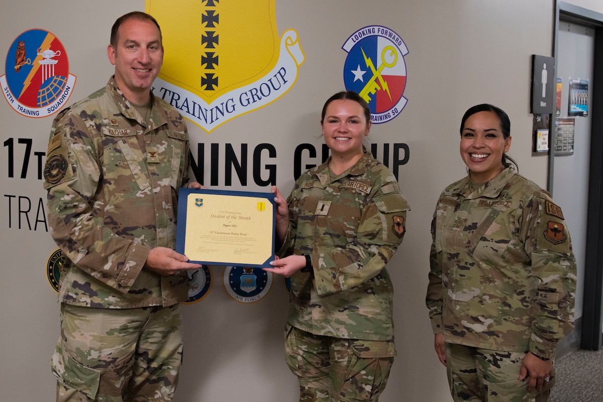 U.S. Air Force Col. Jason Kulchar, 17th Training Group commander, and Chief Master Sgt. Valerie Nededog, 17th TRG senior enlisted leader, present the 315th Training Squadron Student Leader of the Month award to 2nd Lt. Haley Rose, 315th Training Squadron student, at Goodfellow Air Force Base, Texas, September 26, 2022. Rose worked hard for her award and has shown her dedication to her squadron and the training she received at Goodfellow. (U.S. Air Force photo by Senior Airman Michael Bowman)