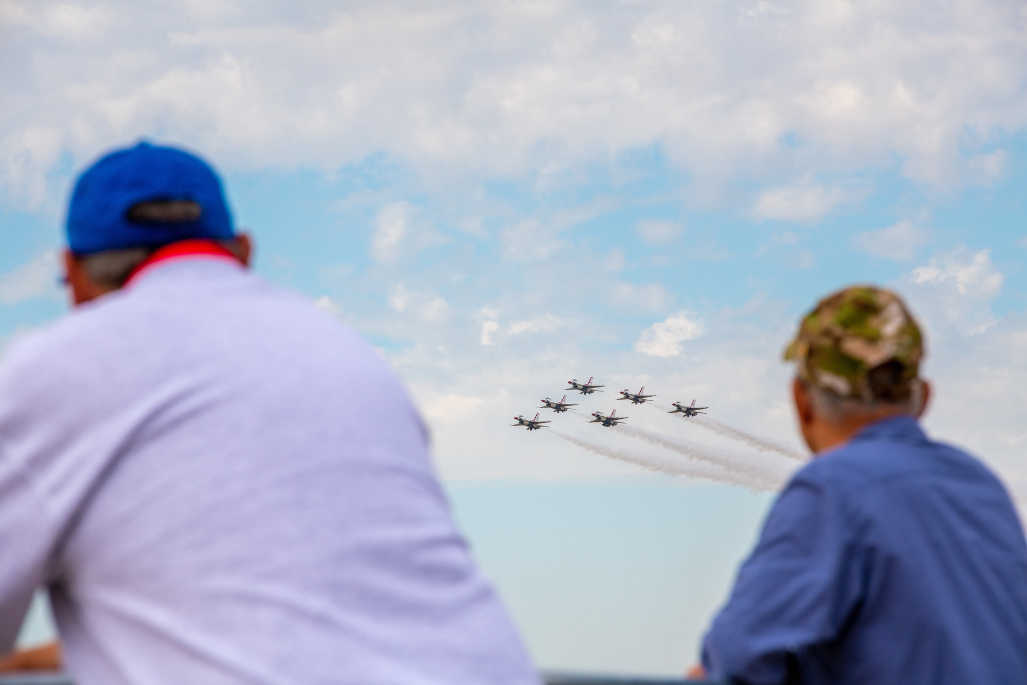 Spectators watch the USAF Thunderbirds perform aerial maneuvers during the Frontiers in Flight airshow practice on Sep. 23, 2022, at McConnell Air Force Base, KS.
