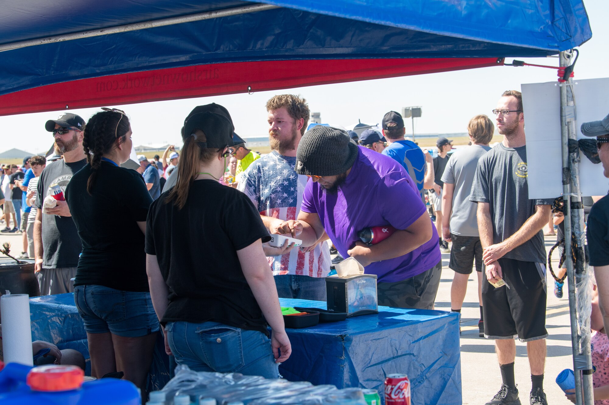 Volunteers serve patrons a variety of different types of food and drinks during the Frontiers in Flight Airshow Sept. 24, 2022 at McConnell Air Force Base, Kan.