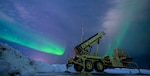 The northern lights glow behind a Patriot M903 launcher station assigned to 5th Battalion, 52nd Air Defense Artillery Regiment, during Exercise ARCTIC EDGE 2022 at Eielson Air Force Base, Alaska, Mar. 5, 2022. The equipment was integrated during AE22 for simulated air and missile defense in austere arctic environments.