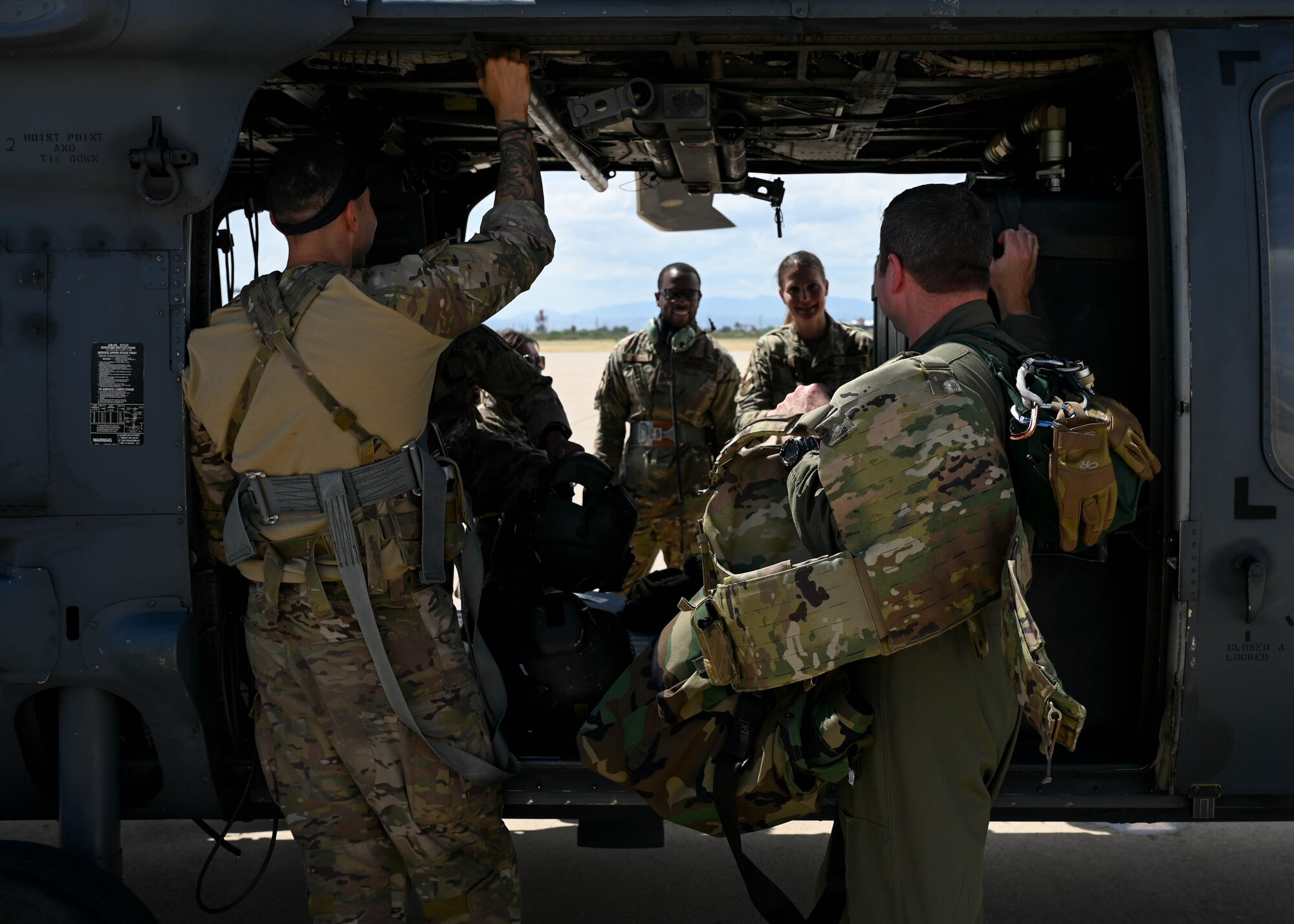 A photo of people standing around a helicopter.