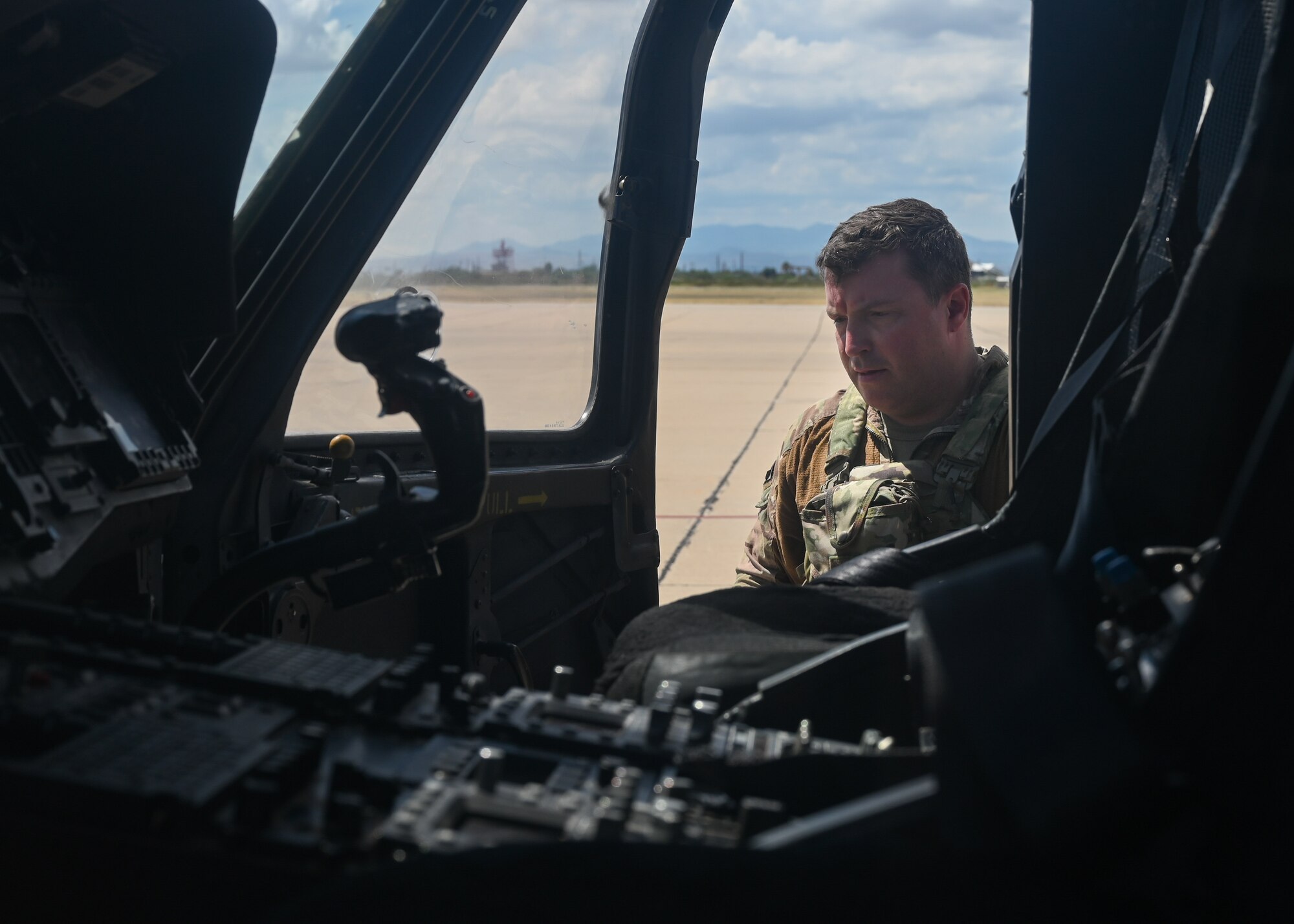 A photo of a man looking at a helicopter.