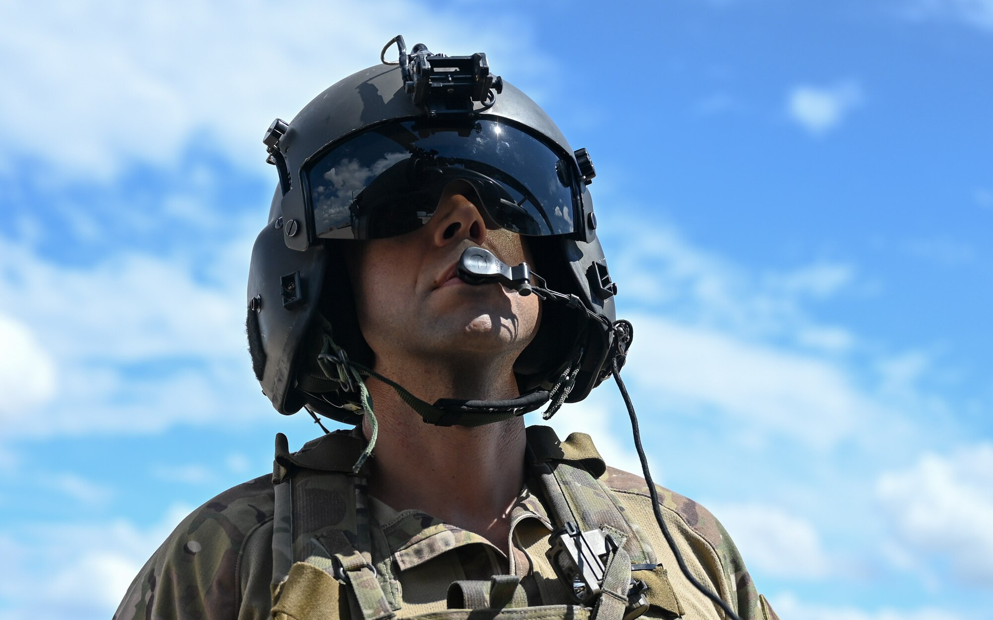 A photo of a man looking at a helicopter.