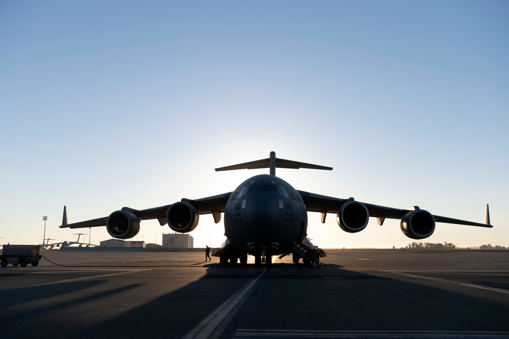 A U.S. Air Force C-17 Globemaster III sits on the flight line at Travis Air Force Base, California, Sept. 23, 2022. A Reserve aircrew from the 301st Airlift Squadron performed a three-day mission Sept. 23 – 25, to move humanitarian cargo to Haiti. Through the Denton Program, three school buses donated from San Diego Unified School District were transported from March Air Reserve Base, California, to Haiti. (U.S. Air Force photo by Senior Airman Jonathon Carnell)