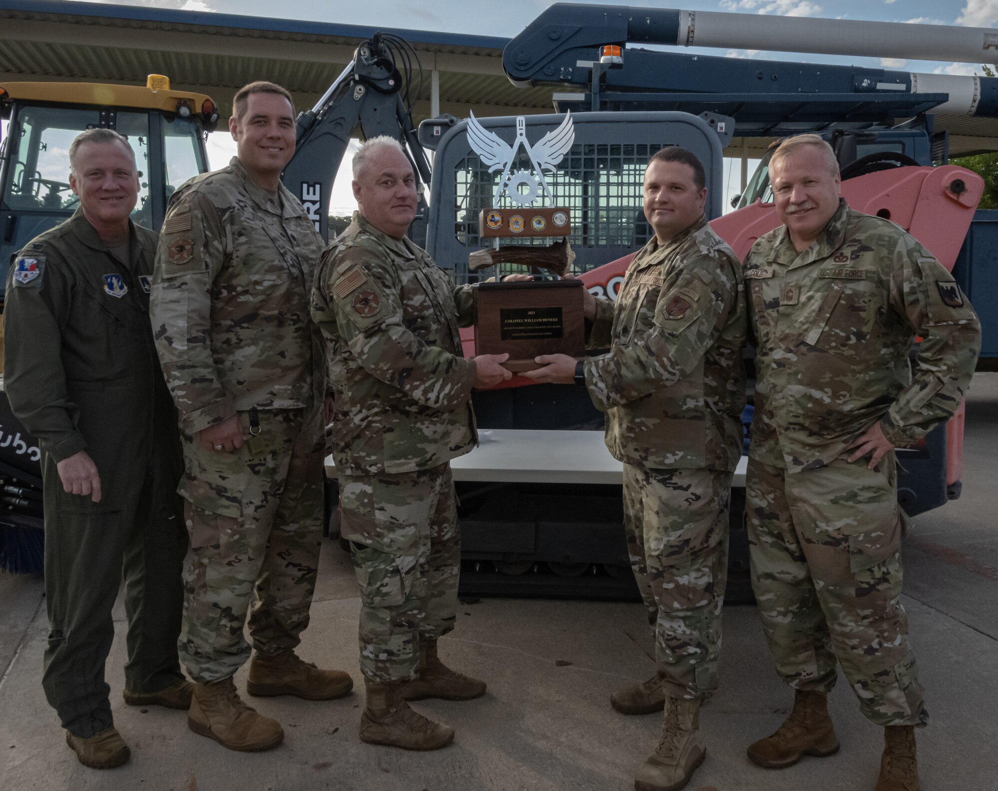 Airmen hold trophy.