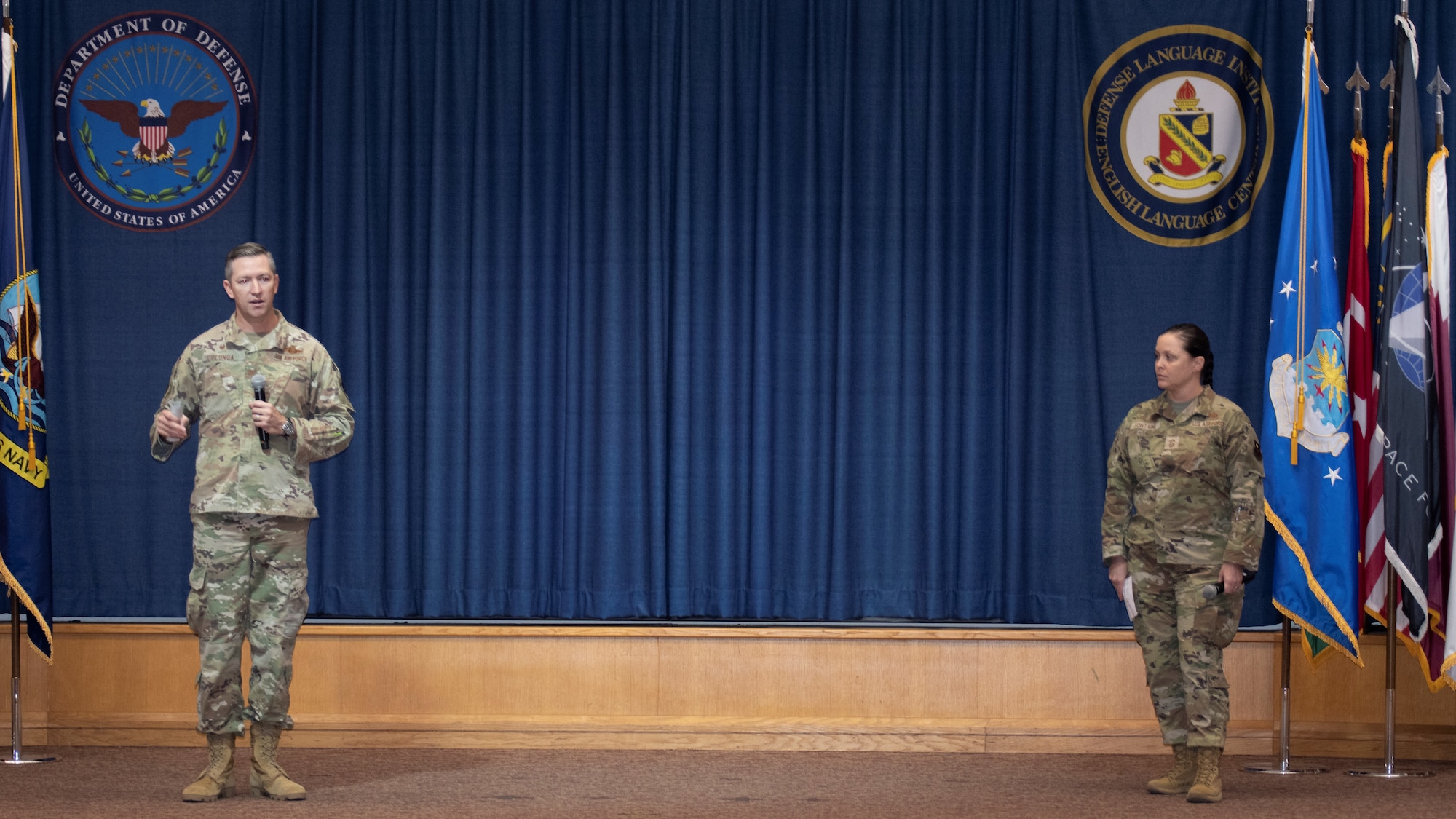 U.S. Air Force Col. Nathan Colunga (left), Special Warfare Training Wing commander, and Command Chief Master Sgt. Tessa Fontaine (right), SWTW command chief, address the audience at the SWTW all-call. At the all-call, the SWTW command team outlined its expectations and priorities for the wing.