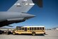 A school bus approaches a C-17 Globemaster III Sept. 23, 2022, at March Air Reserve Base, California. A Reserve aircrew from the 301st Airlift Squadron performed a three-day mission Sept. 23 – 25, to move humanitarian cargo to Haiti. Through the Denton Program, three school buses donated from San Diego Unified School District were transported from March ARB to Haiti. (U.S. Air Force photo by Senior Airman Jonathon Carnell)