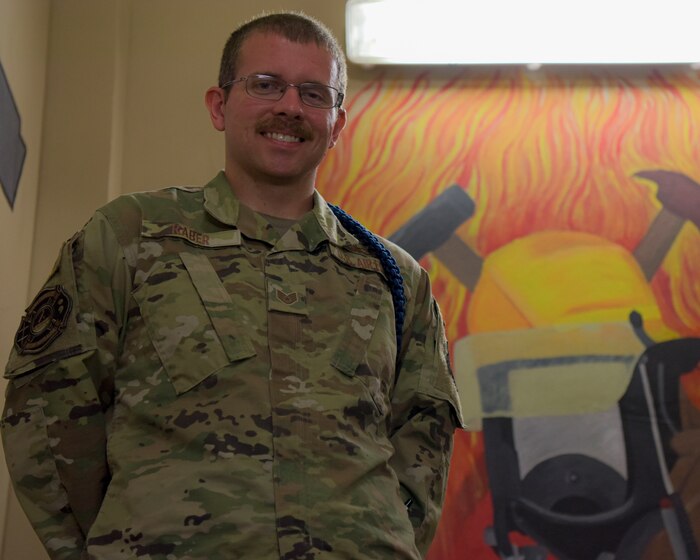 U.S. Air Force Staff Sergeant Derek Raber, 312th Training Squadron military training leader, stands in front of a mural, Goodfellow Air Force Base, Texas, Sept. 14, 2022. Raber has been an MTL at the 312th TRS since March of 2022, overseeing the daily lives of hundreds of Airmen in training. (U.S. Air Force photo by Senior Airman Michael Bowman)