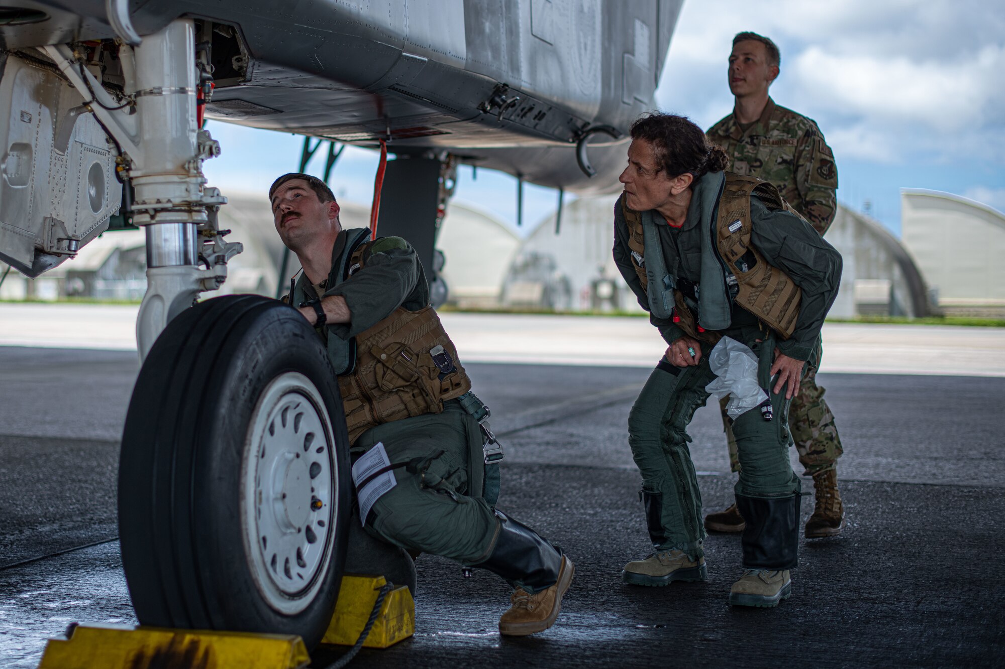 Doctor and pilot check jet.