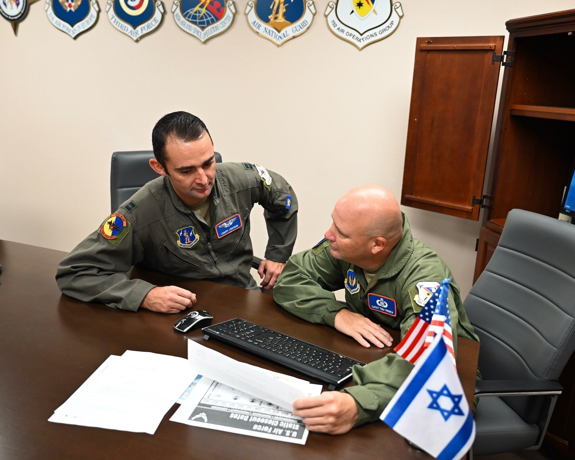 U.S. Air Force Capt Eric Chapman, 152nd Operations Officer and Chief Master Sgt. Toby French, Senior Enlisted Leader 152nd Combat Operations Squadron discuss planning and preparations for the upcoming 2023 JUNIPER exercise in Israel. (U.S. Air National Guard photo by Master Sgt. Barbara Olney)