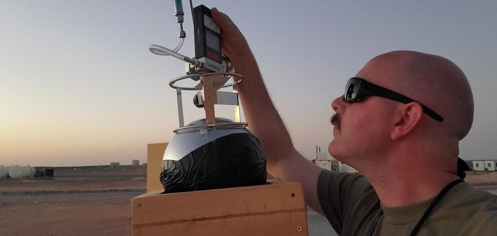Tech. Sgt. Jimmie Buckner, 332d Bioenvironmental Engineering Technician, checks readings of a Summa sampler at an undisclosed location in Southwest Asia, Sept. 10, 2022. Sampling is done to test and track for environmental exposures members of the 332d may be exposed to. (U.S. Air Force photo by Tech. Sgt. Jimmie Buckner)