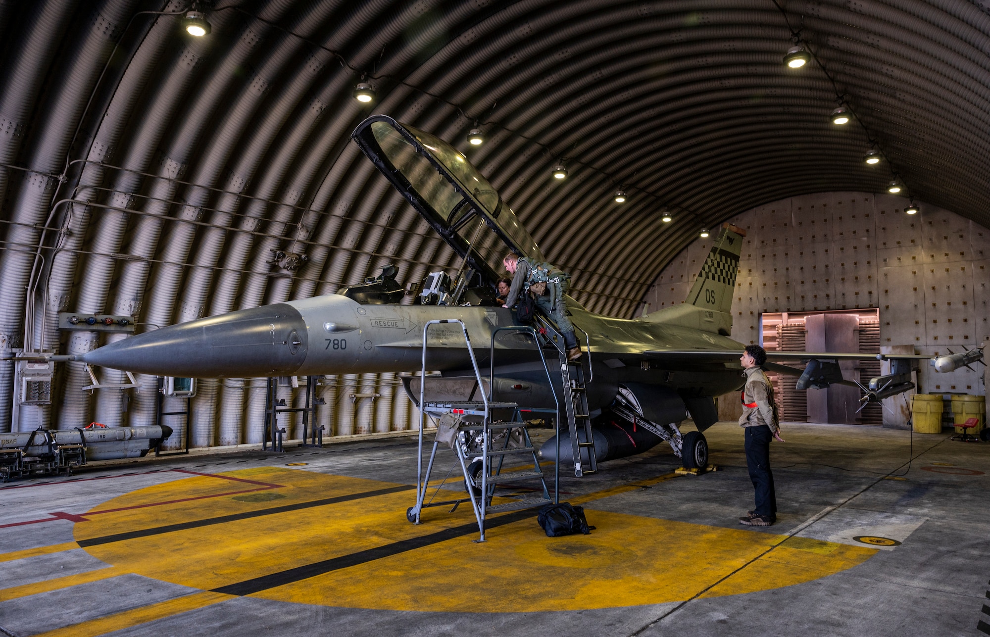 U.S. Air Force Maj. Daniel Wynn, 36th Fighter Squadron director of operations, assists Dr. Victoria Coleman, USAF Chief Scientist, into an F-16 Fighting Falcon at Osan Air Base, Republic of Korea, Sept. 23, 2022.
