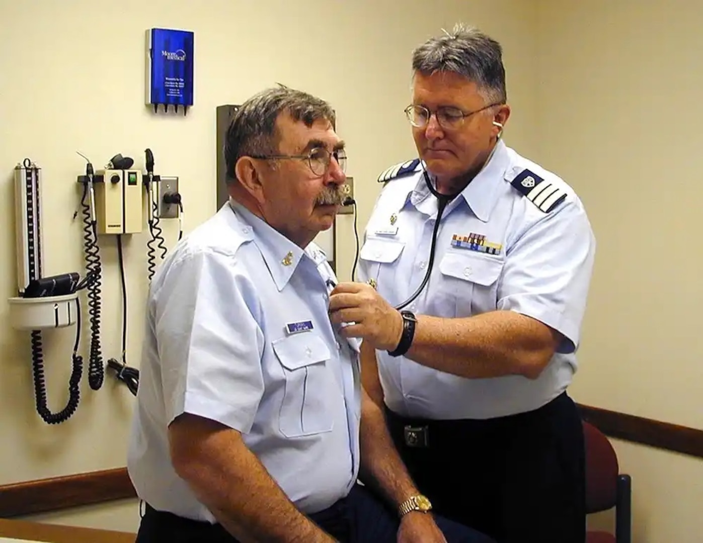 Dr. Victor Connell, a doctor at Coast Guard Training Center Petaluma, gives a medical exam to an active duty Coast Guardsman. Dr. Connell is one of over 100 auxiliarist, medical professionals who volunteer their time and skills to assist the U.S. Coast Guard. USCG photo.