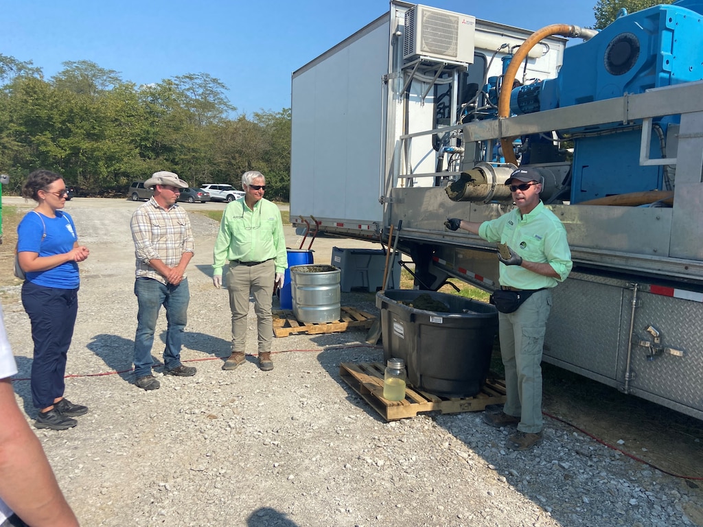 Dr. Martin Page listens to a demonstration of harmful algal bloom technology by industry partner AECOM.