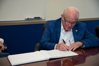 NEWPORT, R.I. (Sept. 20, 2022) Retired U.S. Navy Cmdr. George Easley, first director of the Senior Enlisted Academy (SEA), signs the SEA visitors log after his interview with Naval History and Heritage Command (NHHC) historians, Sept. 20, 2022. NHHC strives to preserve and present an accurate history by locating, collecting, and preserving documents, artifacts, photos, oral histories, and art that best represent the history of the U.S. Navy. (U.S. Navy photo by Mass Communication Specialist 2nd Class Derien C. Luce)