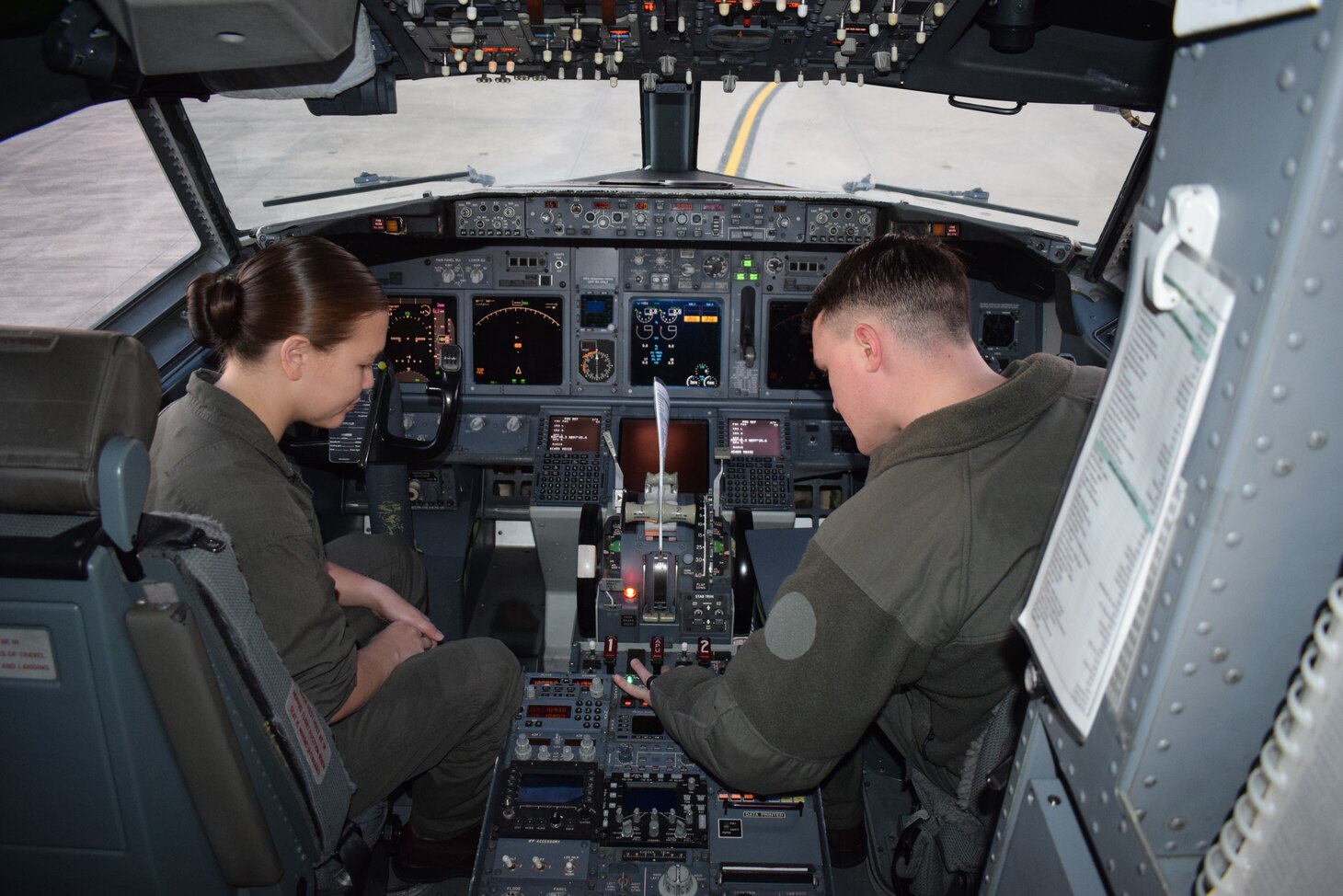 U.S. Marine Corps Staff Sgt. Song, left, a C-40A Clipper crew chief with Marine Transport Squadron 1, Marine Aircraft Group 41, Marine Forces Reserve, instructs the preflight procedures to a C-40A Crew Chief student at Naval Air Station Joint Reserve Base Fort Worth, Texas.