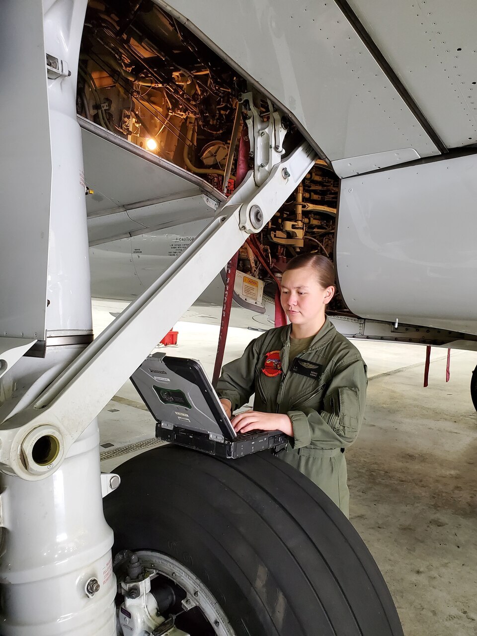 U.S. Marine Corps Staff Sgt. Song, a C-40A Clipper crew chief with Marine Transport Squadron 1, Marine Aircraft Group 41, Marine Forces Reserve, reviews training publications while conducting preventative maintenance on a C-40A Clipper at Naval Air Station Joint Reserve Base Fort Worth, Texas.