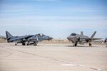 An AV-8B Harrier and an F-35B Lightning II are staged during the change of command and redesignation ceremony for Marine Fighter Attack Squadron (VMFA) 214 aboard Marine Corps Air Station Yuma, Arizona, March, 25, 2022. As part of the transition from the AV-8B Harrier to the F-35B Lightning II, Marine Attack Squadron 214 was re-designated as VMFA-214. The F-35B Lightning II is replacing the AV-8B Harrier to introduce unmatched capabilities to the Marine Corps. The F-35B Lightning II represents a leap forward in air dominance by providing the operational agility and tactical supremacy Marines need to provide expeditious and lethal support.