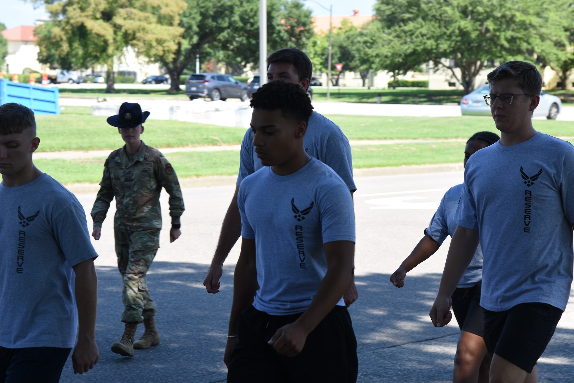 a military training instructor marches new recruits